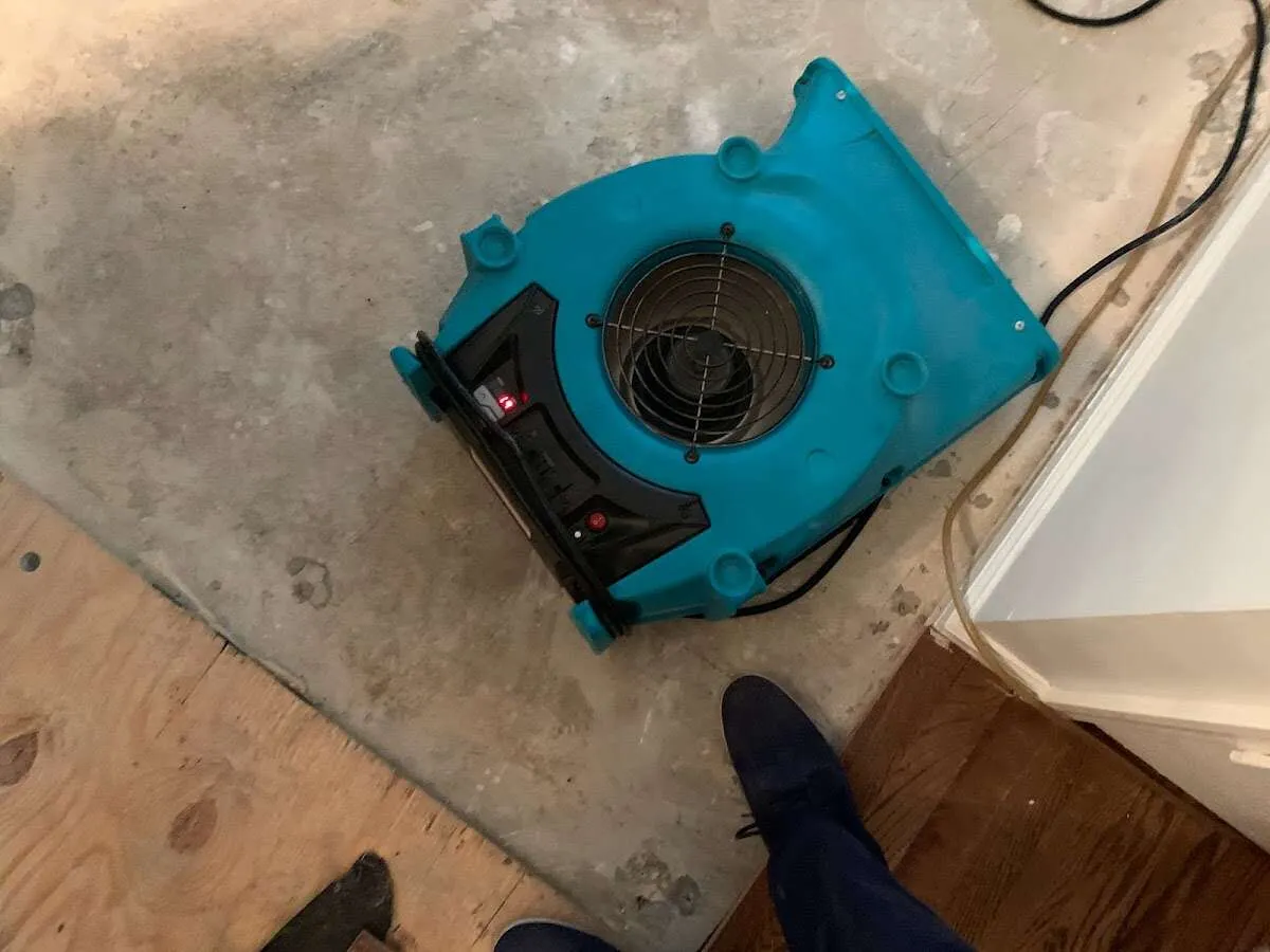 Air mover drying subfloor during Leak Detection & Repair in El Dorado